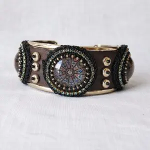 Rigid bracelet with metal and synthetic leather band. Skillaly artisanal product, Made in Italy.