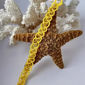 Yellow cotton thread bracelet with matching beads. Authentic Skillaly product, Made in Italy.